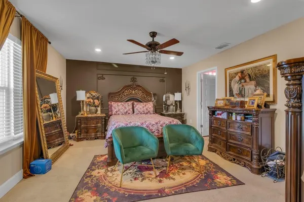 a bedroom with a bed and a mirror