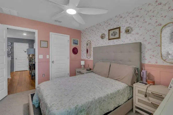 a bedroom with a bed and a chandelier