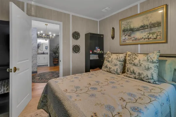 a bedroom with a bed and a large mirror