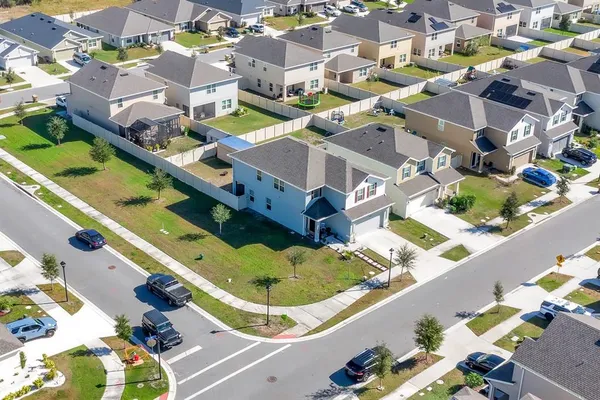 an aerial view of residential houses with outdoor space