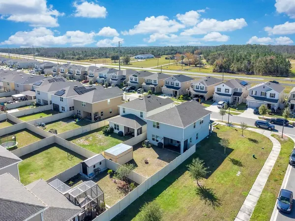 an aerial view of a house with a swimming pool