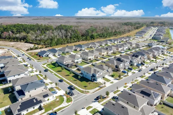 an aerial view of residential houses with outdoor space