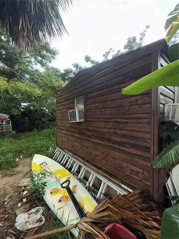 a view of a backyard with chairs and a grill