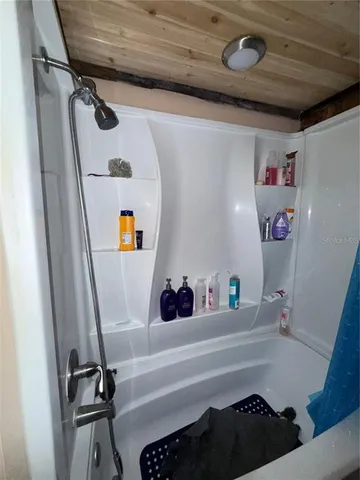a bathroom with a bathtub and a shower