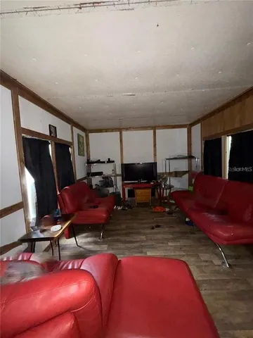 a living room with furniture a rug and a flat screen tv