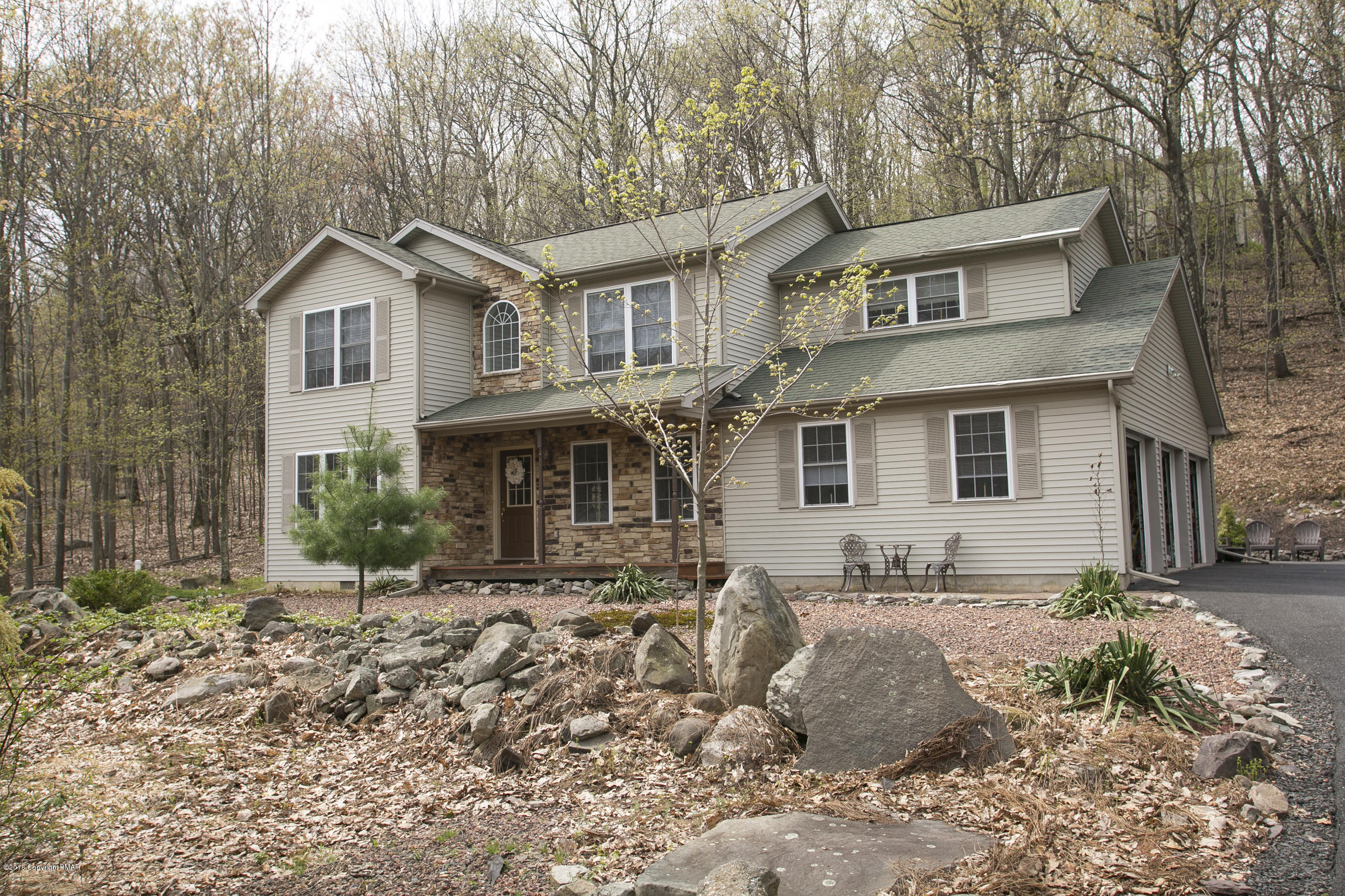 223 Cactus Road Stroudsburg, PA 18360 - Photo 1 of 38 a front view of a house with a yard covered with snow and trees