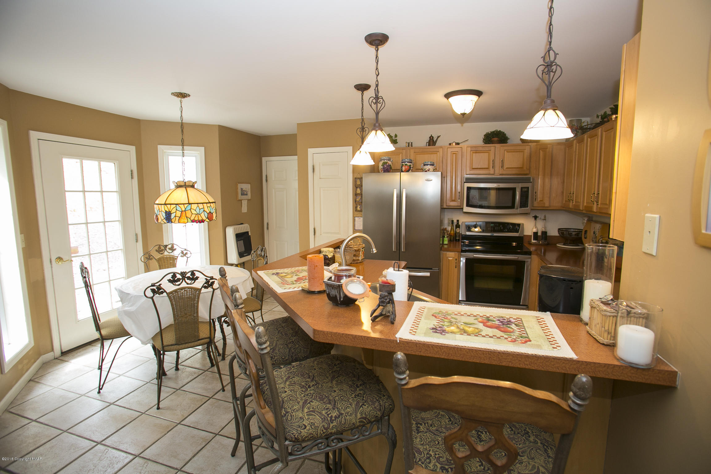 223 Cactus Road Stroudsburg, PA 18360 - Photo 2 of 38 a kitchen with a dining table chairs and refrigerator