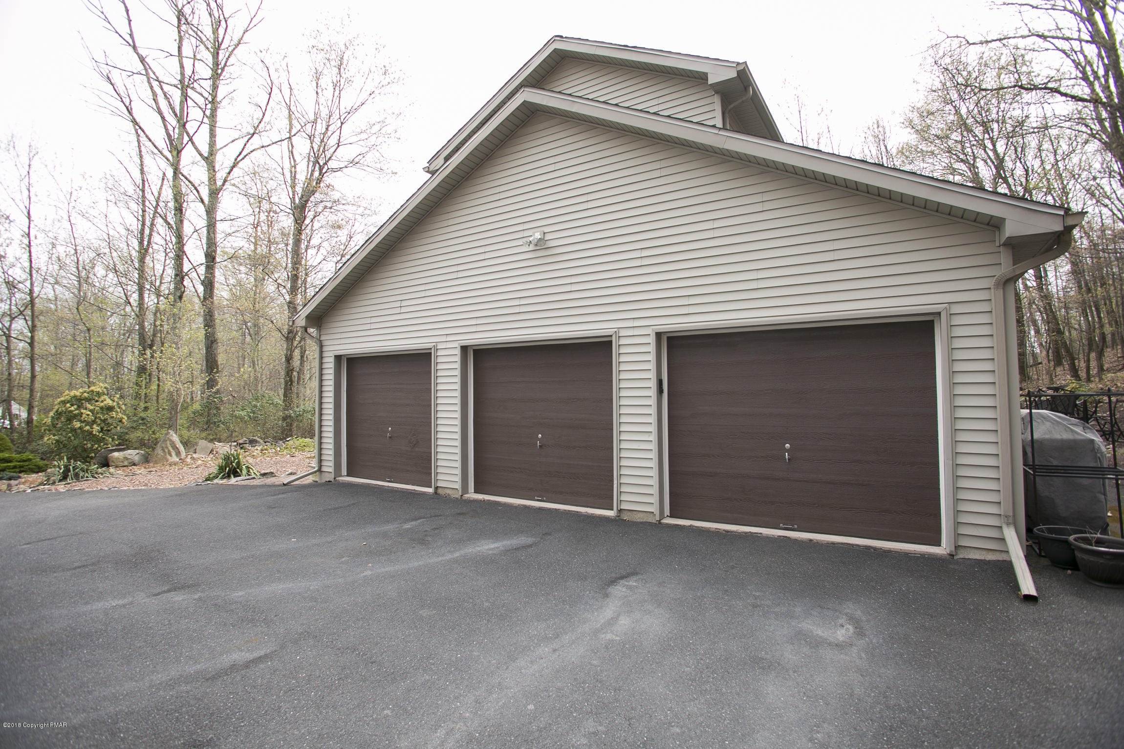 223 Cactus Road Stroudsburg, PA 18360 - Photo 36 of 38 a view of a house with a yard and garage