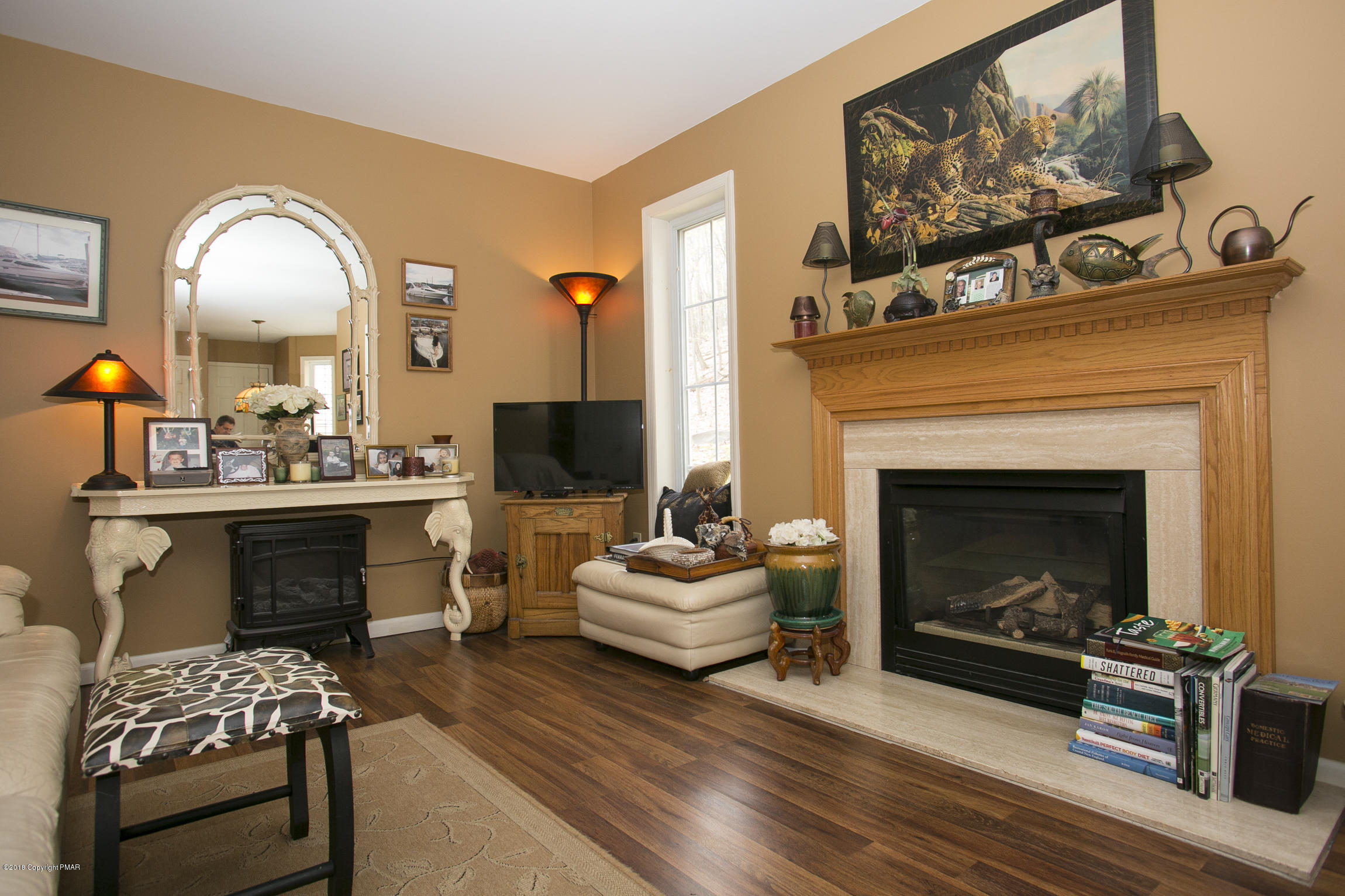 223 Cactus Road Stroudsburg, PA 18360 - Photo 8 of 38 a living room with furniture and a fireplace