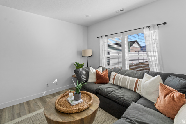 1264 West 500 South, Unit 320 Logan, UT 84321 - Photo 5 of 39 Spacious living area featuring light wood-finish flooring, white baseboards, and bright white walls