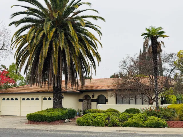 a front view of a house with a garden