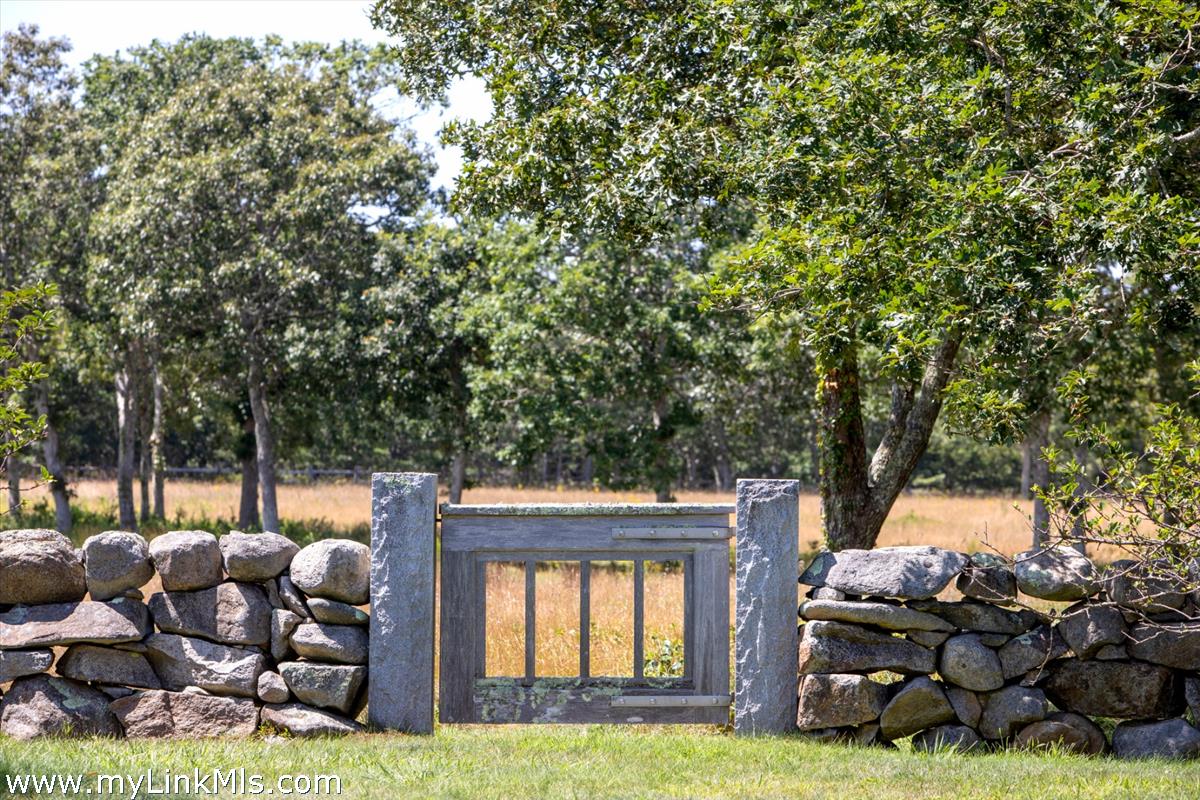 32 Boldwater Road Edgartown, MA 02539 - Photo 15 of 55 a backyard of a house with barbeque oven