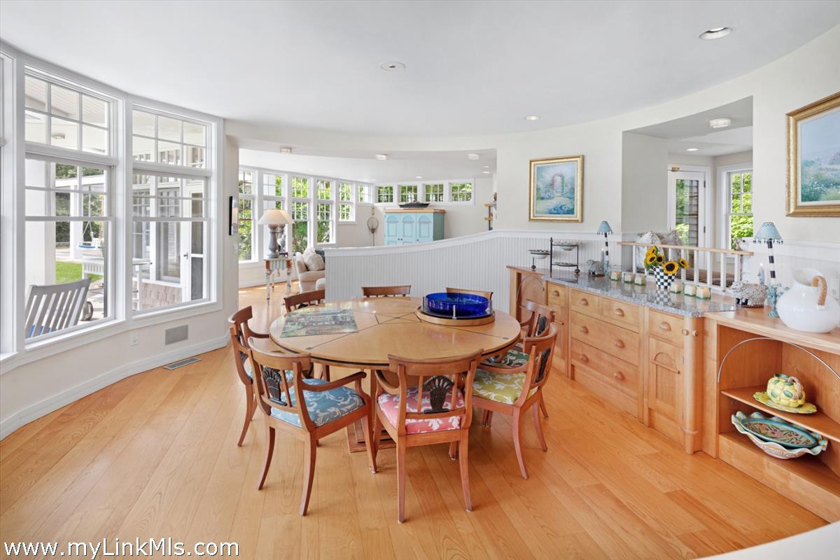 32 Boldwater Road Edgartown, MA 02539 - Photo 23 of 55 a view of a dining room with furniture a chandelier and wooden floor