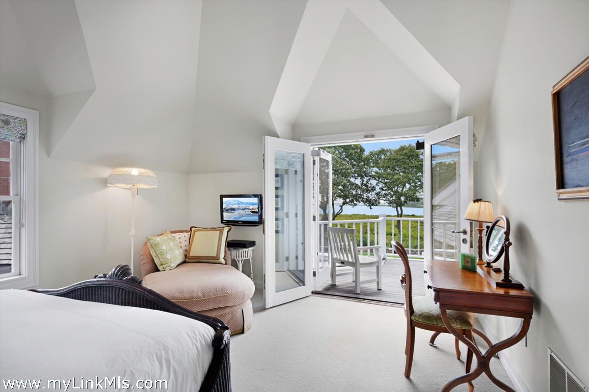 32 Boldwater Road Edgartown, MA 02539 - Photo 39 of 55 a bedroom with a bed and large windows