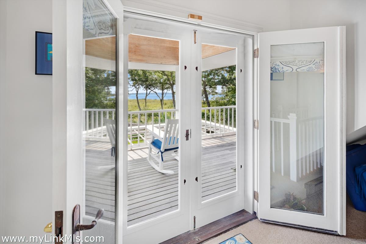 32 Boldwater Road Edgartown, MA 02539 - Photo 45 of 55 a view of a balcony with wooden floor and door