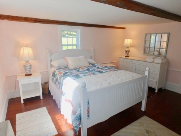 76 Ben Chase Road West Tisbury, MA 02568 - Photo 11 of 20 a bed sitting in a bedroom next to a window