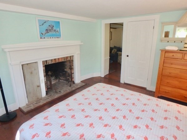 76 Ben Chase Road West Tisbury, MA 02568 - Photo 12 of 20 a bedroom with a bed and a fireplace