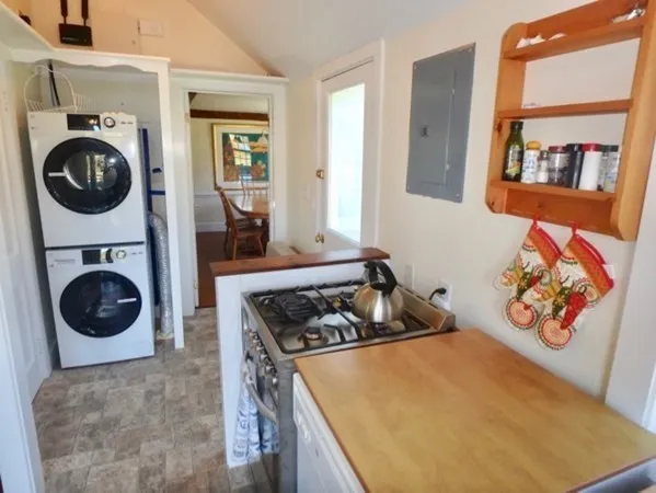a kitchen with stainless steel appliances granite countertop a stove a washer and dryer