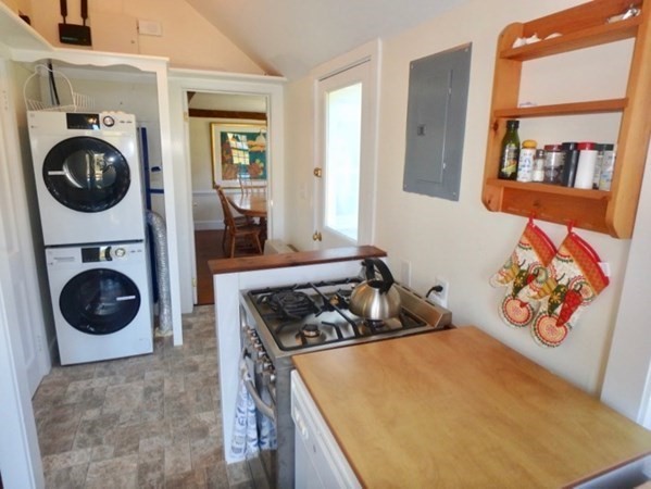 76 Ben Chase Road West Tisbury, MA 02568 - Photo 14 of 20 a kitchen with stainless steel appliances granite countertop a stove a washer and dryer