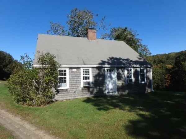 a view of house with yard and green space