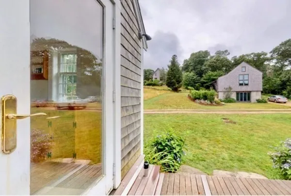 a view of a balcony with floor to ceiling windows with wooden floor