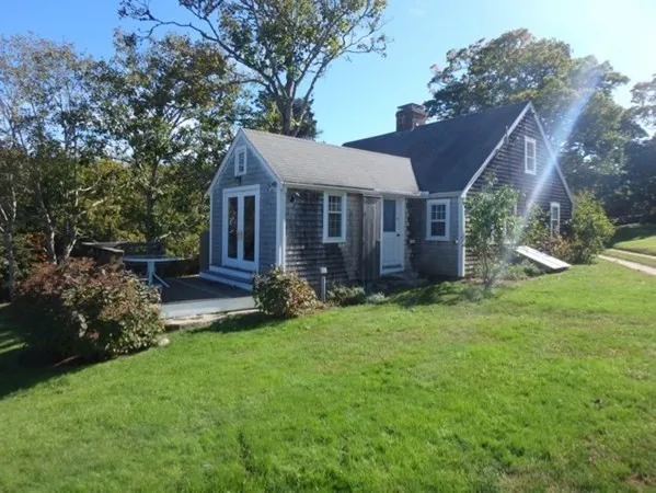 a view of house with backyard and garden