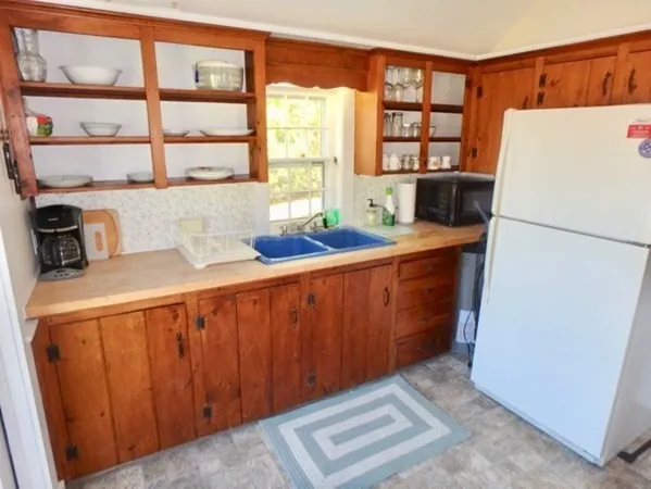 a kitchen with stainless steel appliances a refrigerator and a sink
