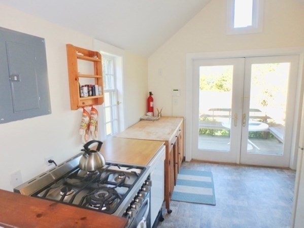 76 Ben Chase Road West Tisbury, MA 02568 - Photo 6 of 20 a kitchen with a stove and a wooden floor