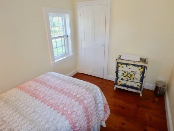 76 Ben Chase Road West Tisbury, MA 02568 - Photo 9 of 20 a bedroom with a bed and a window