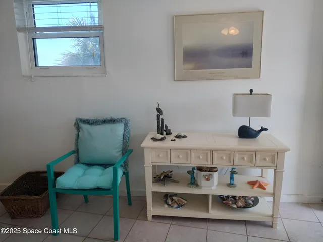 a kitchen with a white cabinets and chairs