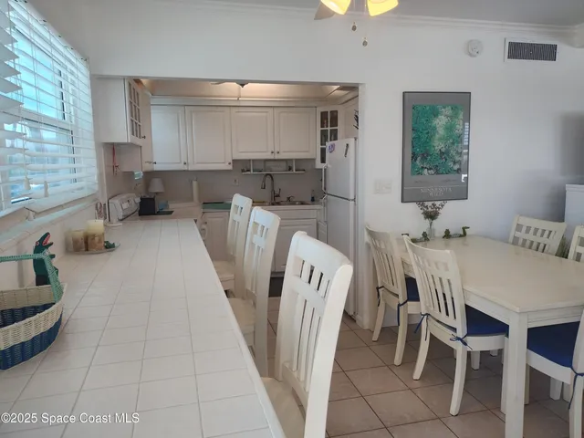 a view of cabinets a sink and a stove in a kitchen