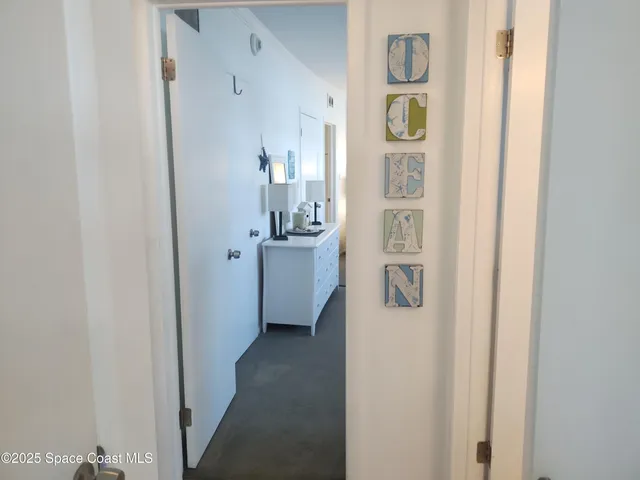 a spacious bedroom with a bed and a cabinets