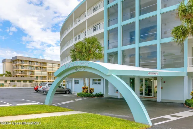 a front view of a building with a garden