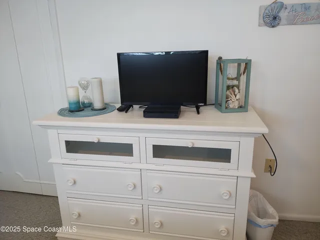 a white toilet sitting next to a shower