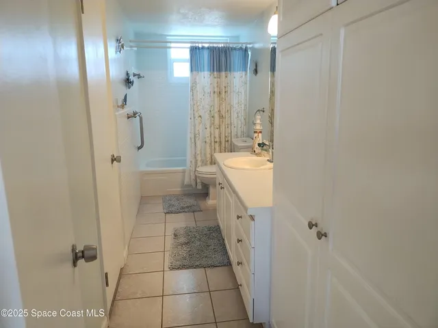 a living room with furniture and a glass door
