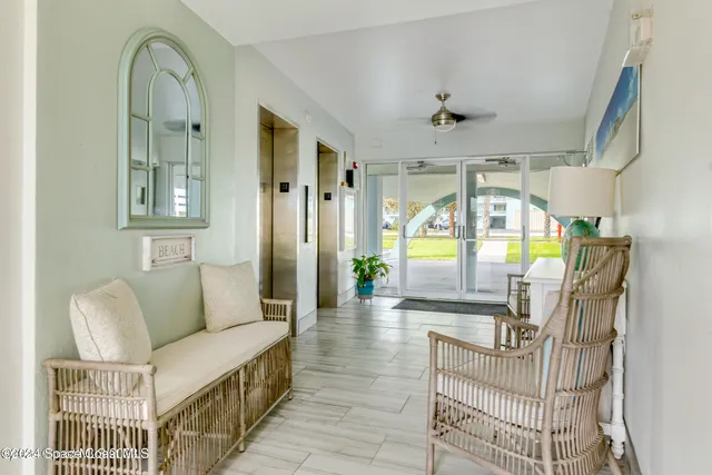 a room with view of living room and a floor to ceiling window