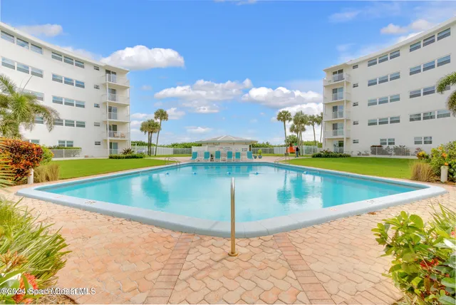 a view of a swimming pool with an outdoor seating
