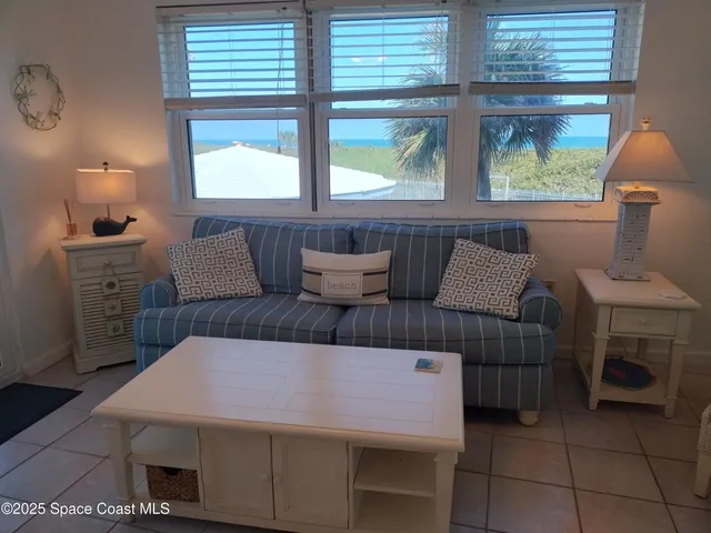 a living room with furniture a window and a table