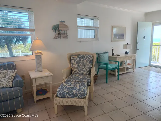 a living room with furniture and a lamp