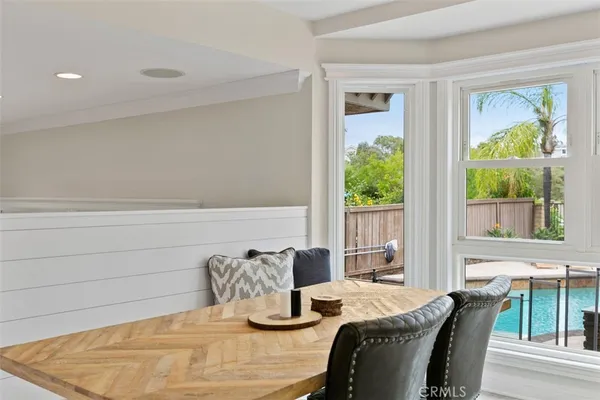 a dining room with furniture and a window