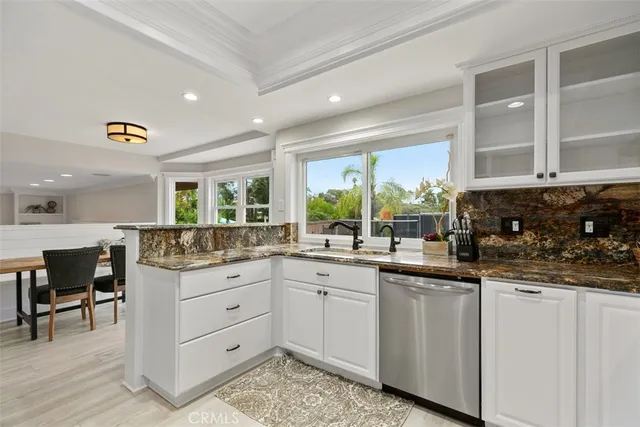 a kitchen with sink and cabinets