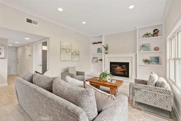 a living room with furniture and a view of kitchen