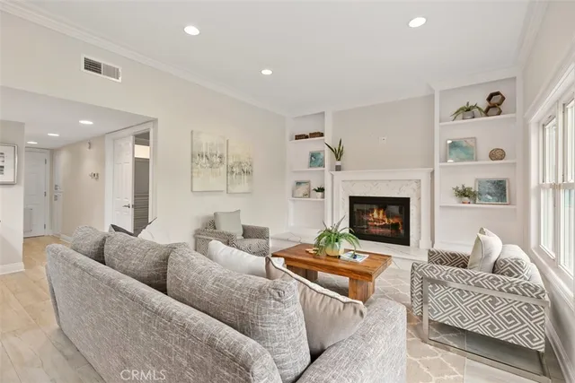 a living room with furniture and a view of kitchen