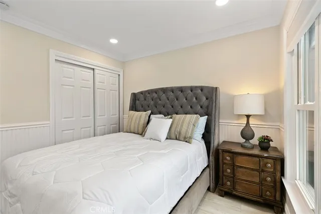 a bedroom with two beds and a large window