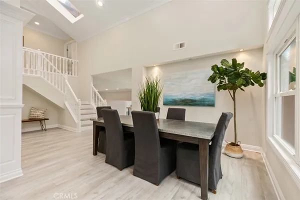 a view of a dining room with furniture and a potted plant