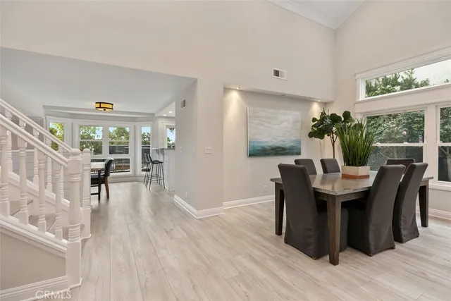 a dining room with furniture window and wooden floor