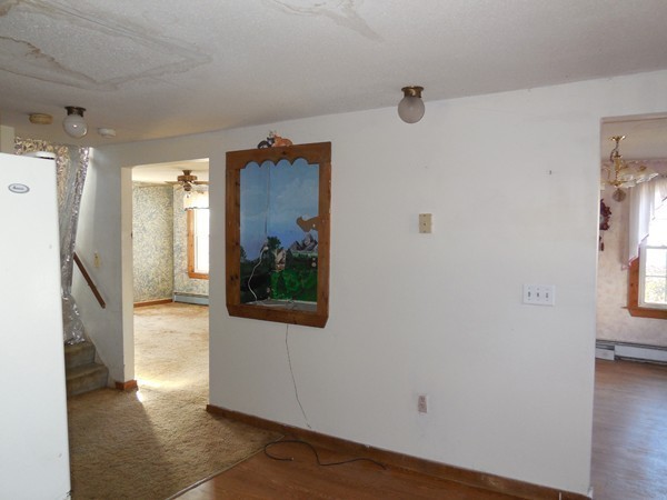 27 Upper Palmer Road Monson, MA 01057 - Photo 11 of 25 a view of a hallway with wooden floor and a living room
