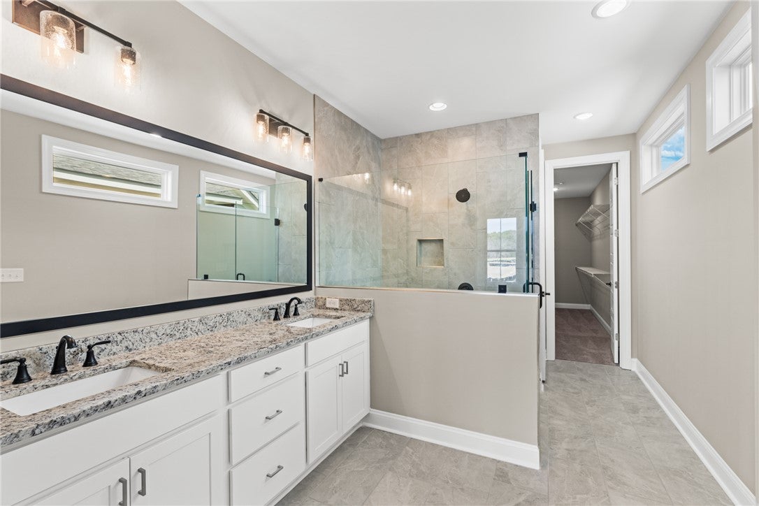 320 Coscoroba Road Auburn, AL 36832 - Photo 9 of 27 This spacious bathroom offers elegant finishes and a seamless transition to the primary closet.
