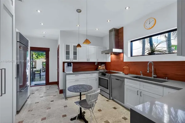 a kitchen with stainless steel appliances a sink stove and cabinets