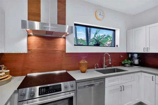 a kitchen with a sink and a stove